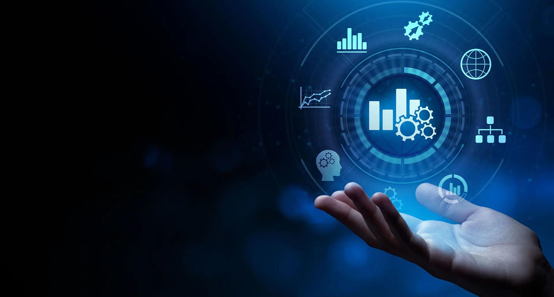 A human hand with palm up, digitally overlaid with various glowing blue futuristic interface elements, including graphs, gears, a human head silhouette with gears in the brain area, network structures, and a globe, symbolizing concepts of technology, data analytics, and artificial intelligence.